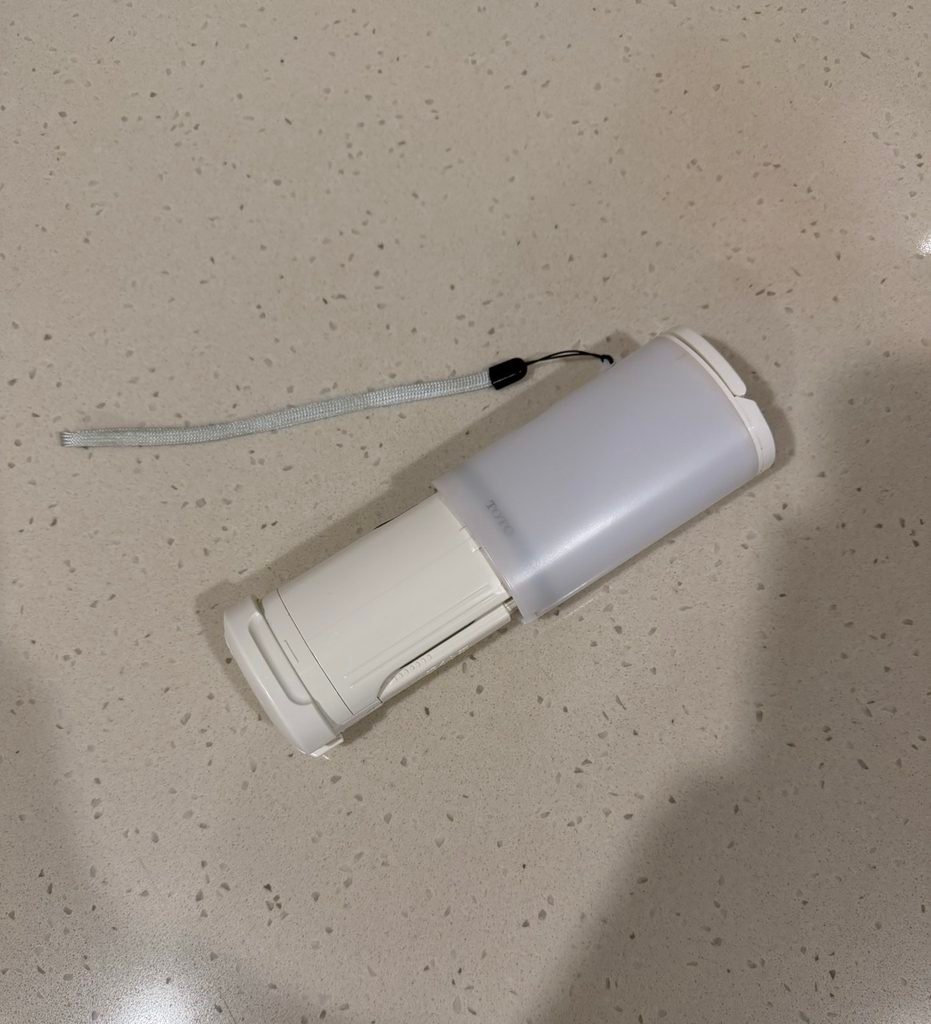 A handheld TOTO travel washlet bidet.